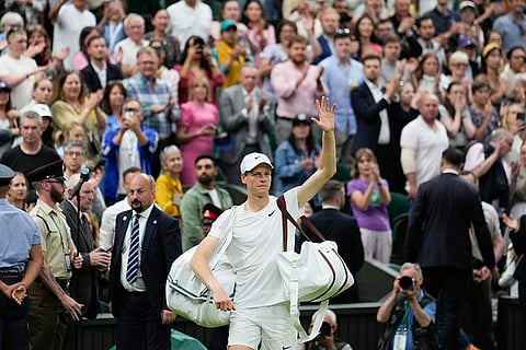 Jannik Sinner waves as he leaves the court following his quarterfinal loss to Daniil Medvedev